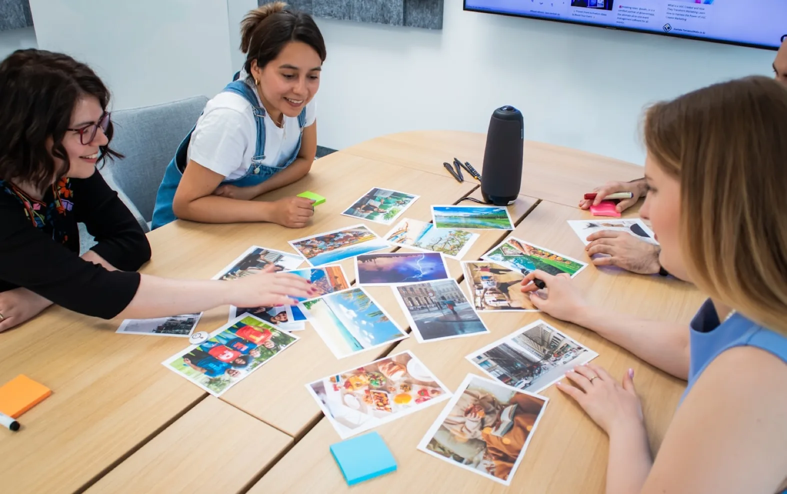 CAPS team members sorting photographs around a meeting table